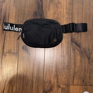 Black Lulu Lemon Everywhere belt bag  with logo on strap . Excellent condition